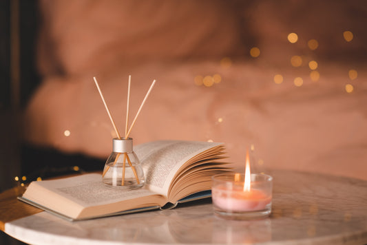 Candle and book on a marble coffee table